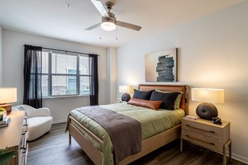 Bedroom with oversized windows with curtains